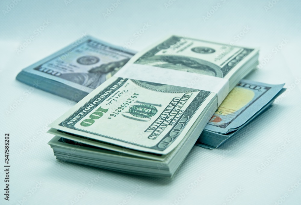 wad of 100 dollar bills in a white background wad of 100 dollar bills in a white background
