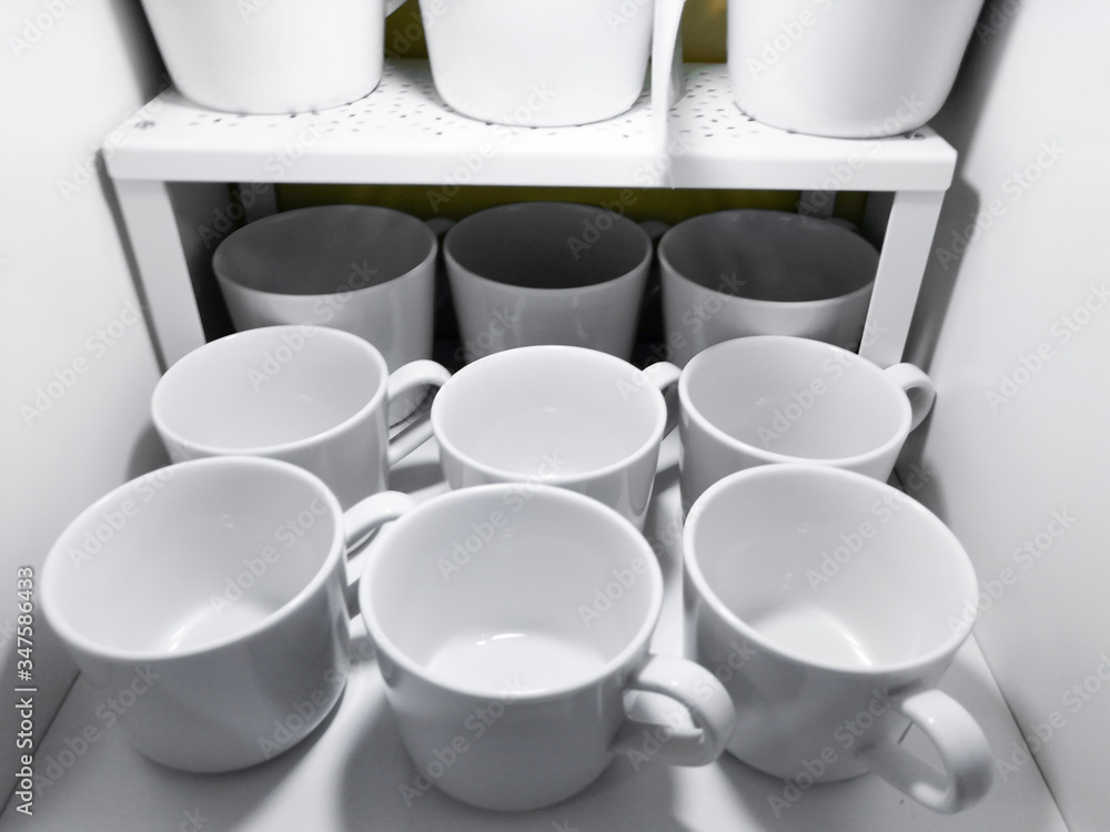 lots of white cups. Top view on many stacked in rows of empty clean white cups for tea or coffee lots of white cups. Top view on many stacked in rows of empty clean white cups for tea or coffee