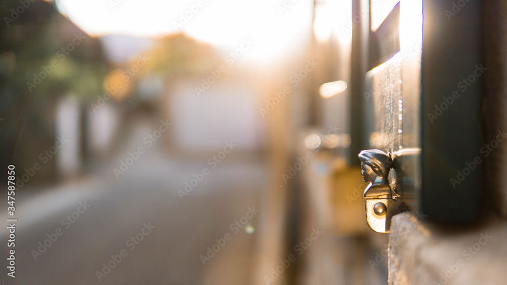 Decorating woman's head on a wooden window shutter with sunrays at sunset at home Decorating woman's head on a wooden window shutter with sunrays at sunset at home