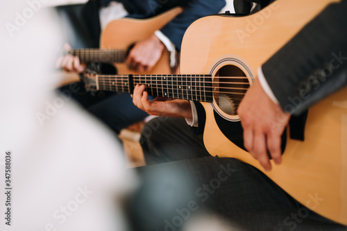 photo of a man playing on the guitar
