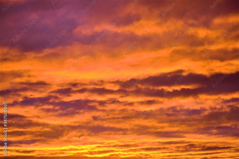 Evening sky in dense clouds of bright orange color