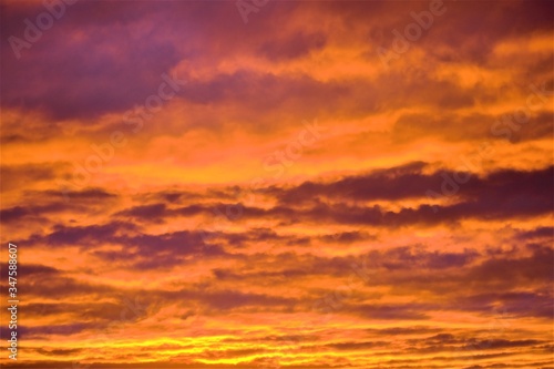 Evening sky in dense clouds of bright orange color