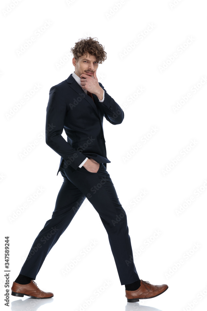 Side view of confident businessman holding hand on chin Side view of confident businessman holding hand on chin