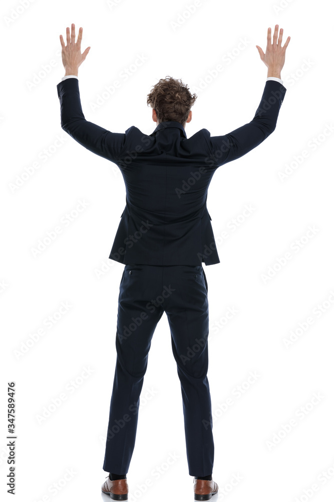 Rear view of guilty businessman freezing as being caught Rear view of guilty businessman freezing as being caught
