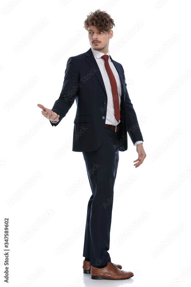 Side view of serious businessman looking over shoulder Side view of serious businessman looking over shoulder