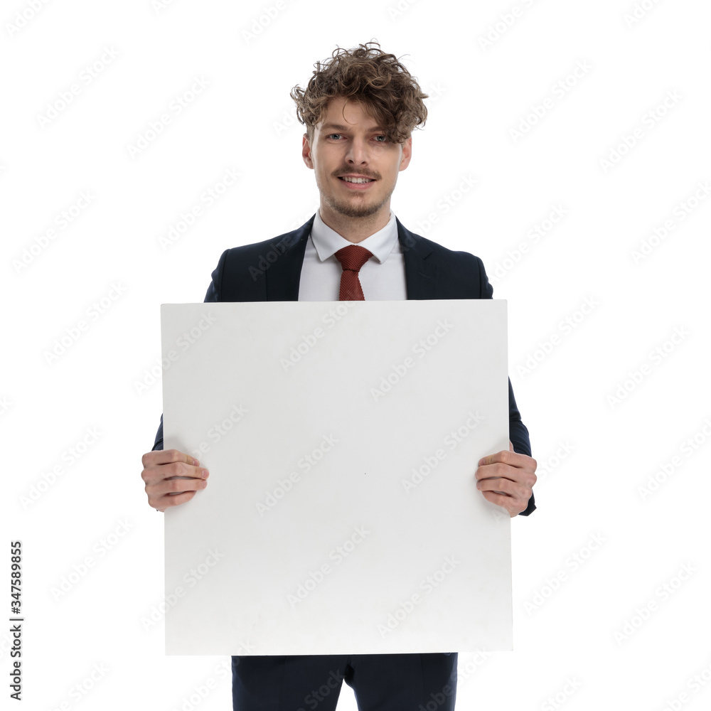 Positive businessman holding billboard and smiling Positive businessman holding billboard and smiling