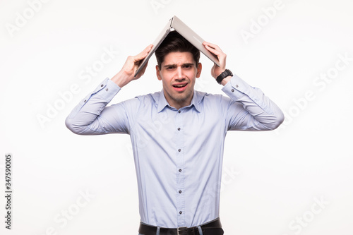 Portrait of a cheerful businessman holding laptop over head on white background