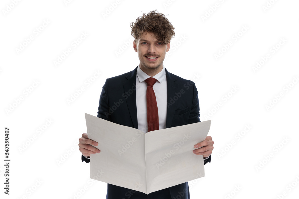 Happy businessman reading newspaper and smiling Happy businessman reading newspaper and smiling