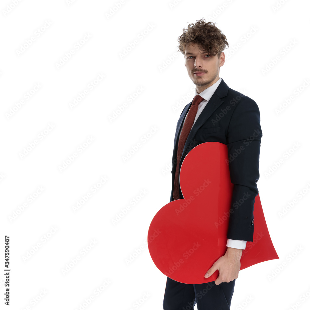 Serious businessman holding heart shape Serious businessman holding heart shape