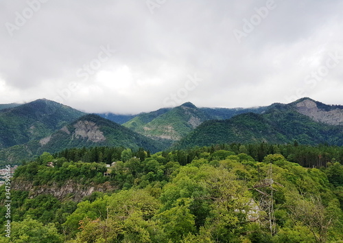 Mountains covered with dense forests under a cloudy sky in Borjomi, Georgia