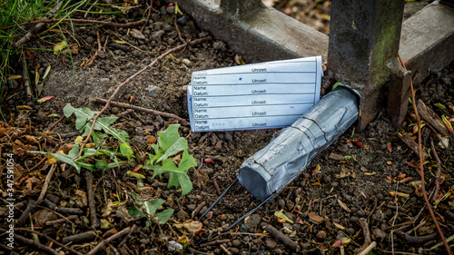 geocache container encased with duct tape and logbook hidden inside a  fence photo