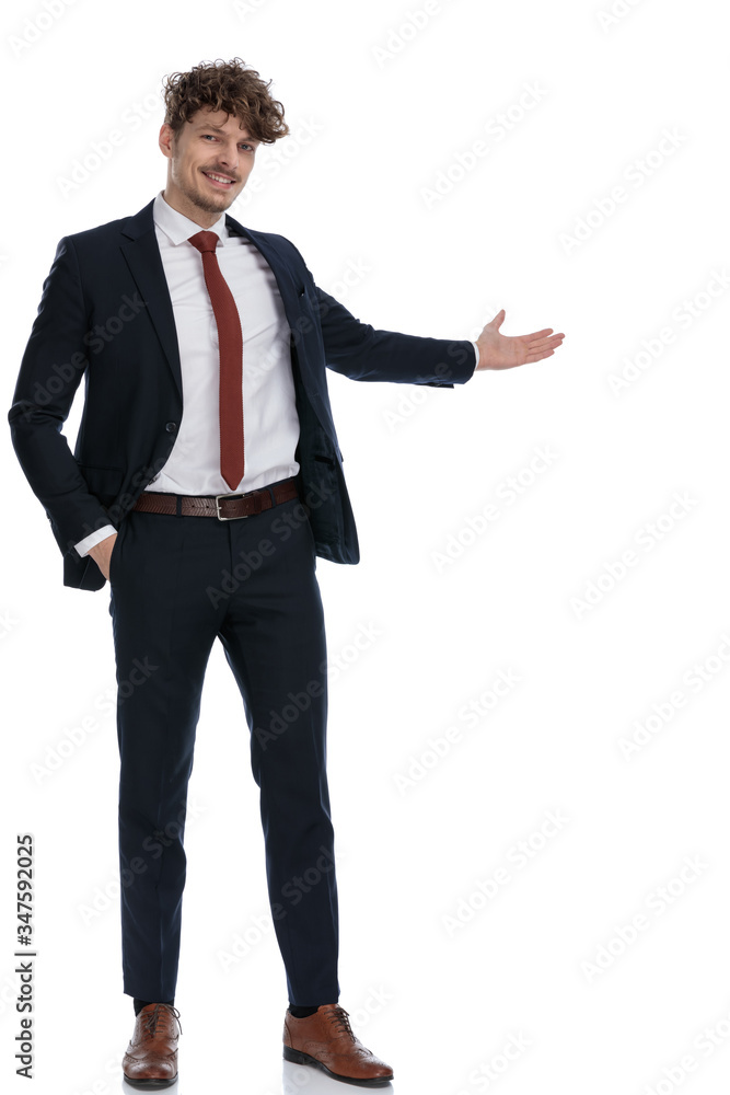 Smiling businessman presenting with his hand in his pocket Smiling businessman presenting with his hand in his pocket