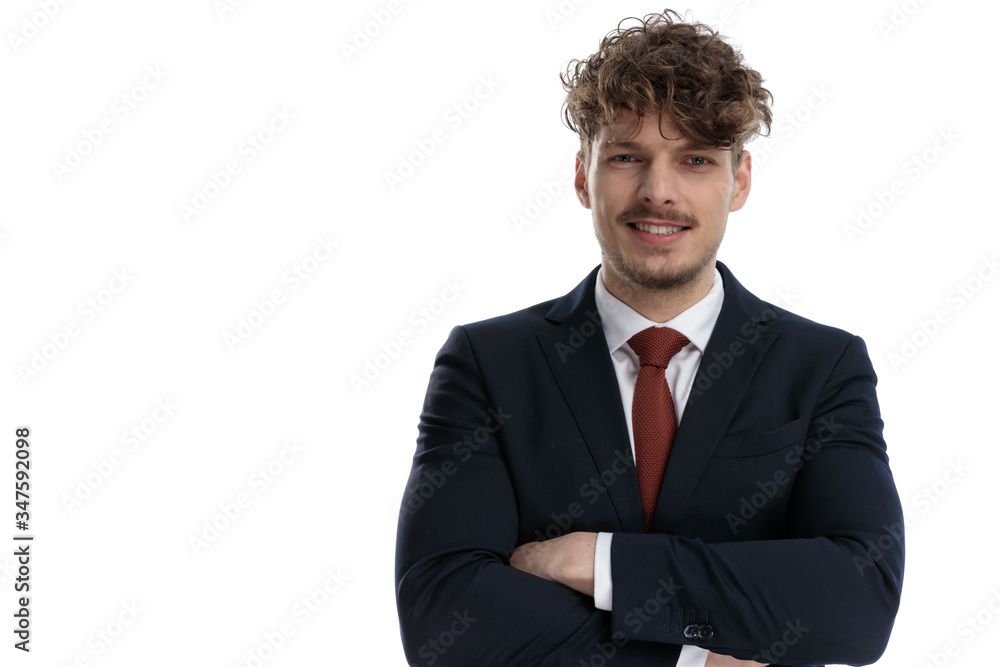 Positive businessman smiling with arms folded Positive businessman smiling with arms folded
