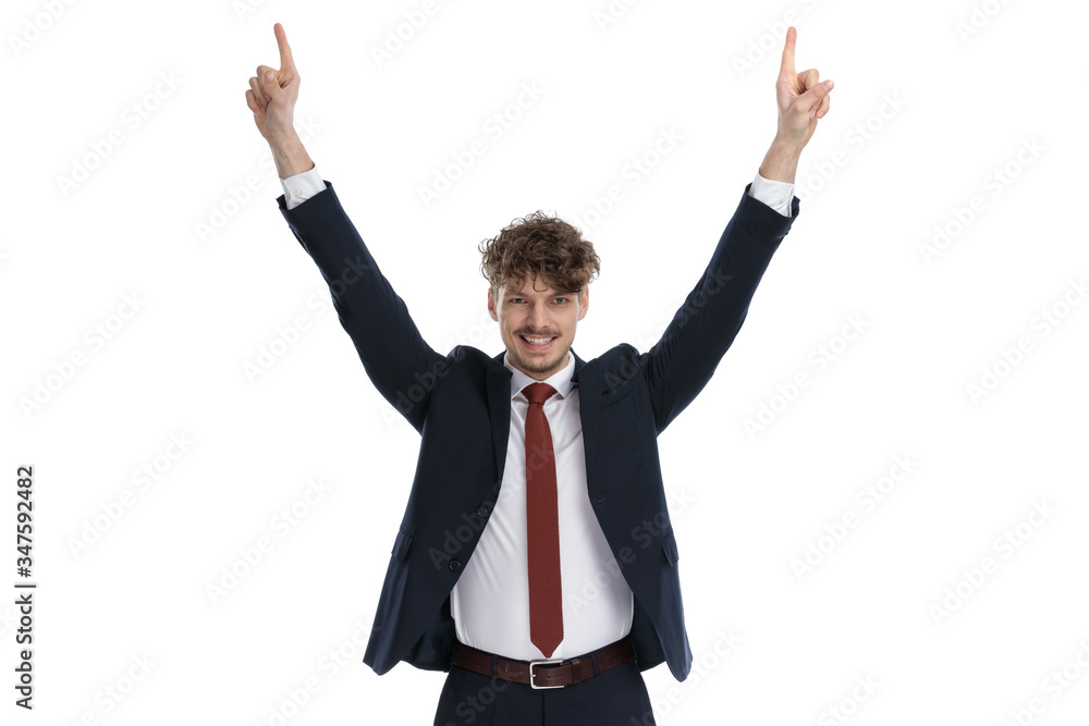 Happy businessman smiling and pointing up with both hands Happy businessman smiling and pointing up with both hands