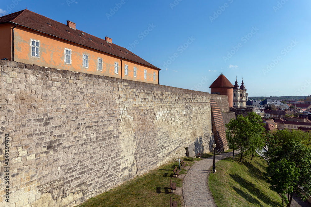 The wall of the Eger Castle in Hungary on a sunny afternoon with the Dobo bastion in the background.