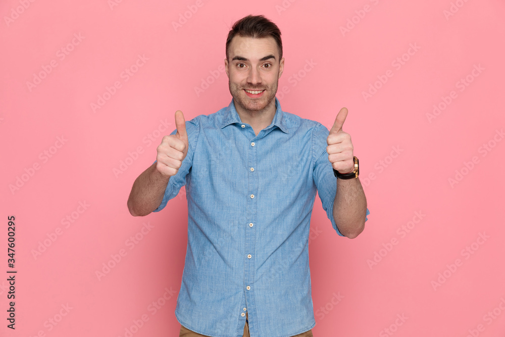 casual man giving a thumbs up with both hands casual man giving a thumbs up with both hands