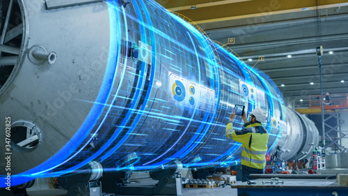 Fotografie AR Concept: Industrial Engineer Uses Augmented Reality Digital Tablet to Scan Large Metal Construction, Special Effects Show Visualization / Digitalization of Oil, Gas and Fuel Transport Pipeline