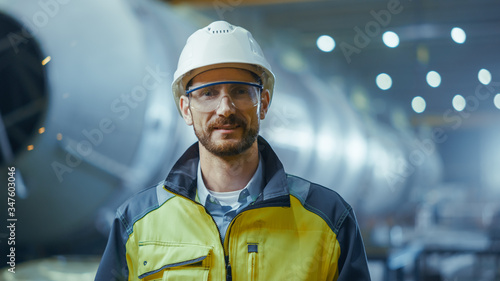 Tablou canvas Portrait of Smiling Professional Heavy Industry Engineer / Worker Wearing Safety Uniform, Goggles and Hard Hat