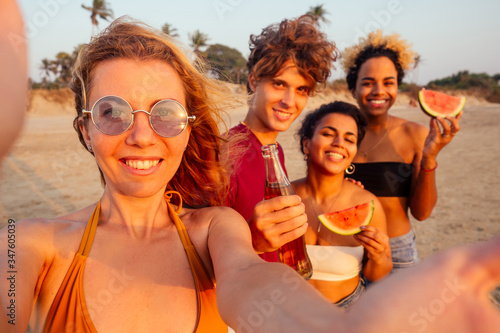 mixed race people taking photos and video together on smartphone camera