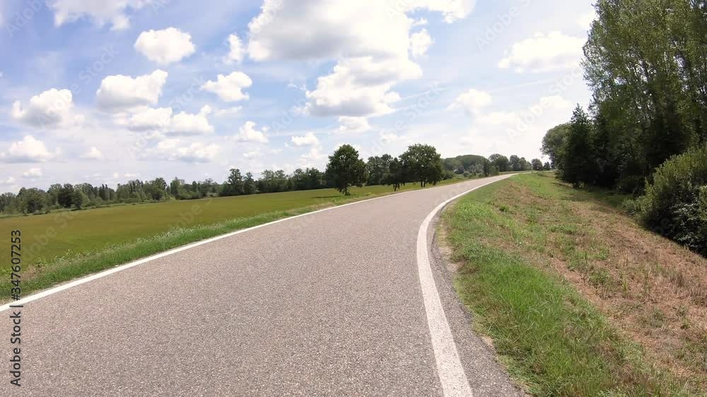 a country paved road on the Embankment along the Ticino river next to Carbonara al Ticino, province of Pavia, Lombardy, Italy a country paved road on the Embankment along the Ticino river next to Carbonara al Ticino, province of Pavia, Lombardy, Italy