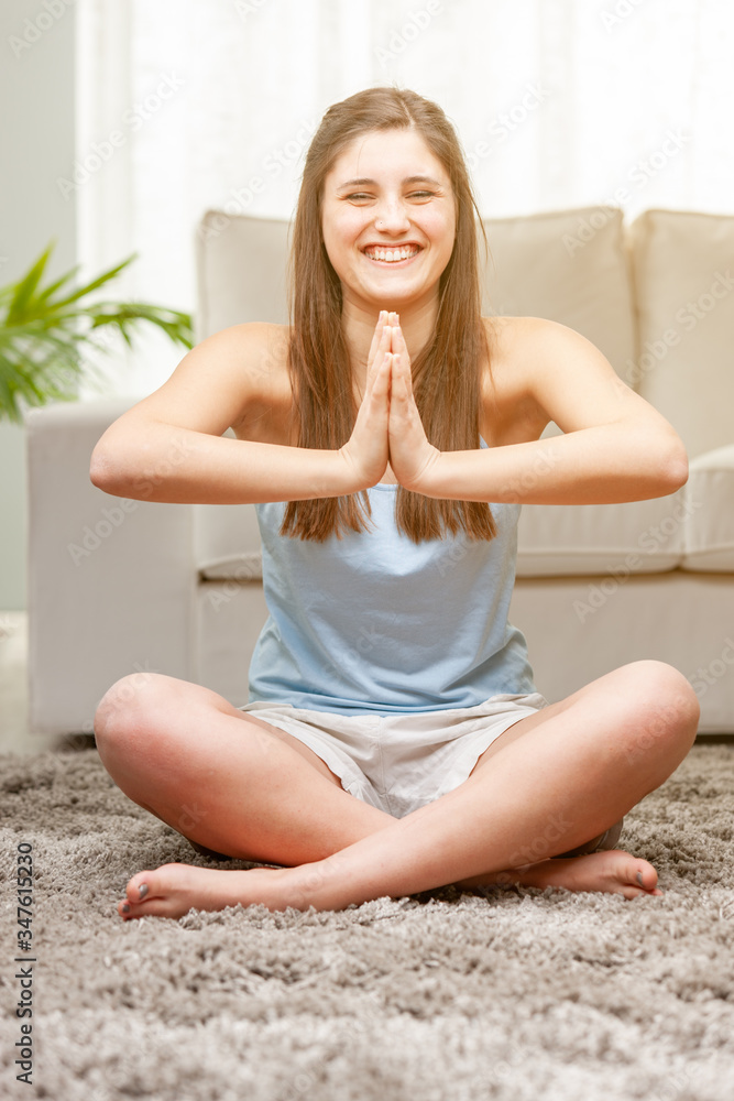 Smiling vivacious young woman practicing yoga Smiling vivacious young woman practicing yoga