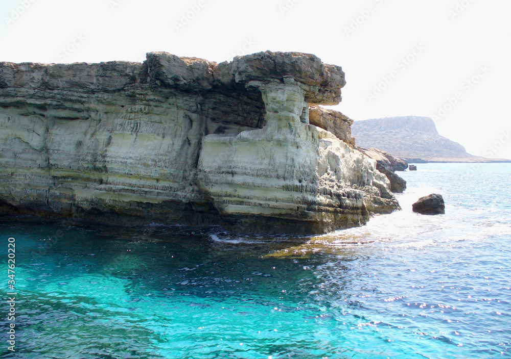 Cave in the mountain on the blue sea.Cape Greco and the blue lagoon