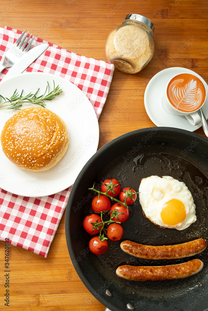 overhead shot of fried breakfast American sausage egg tomatoes roll coffee quick tasty first healthy big portion