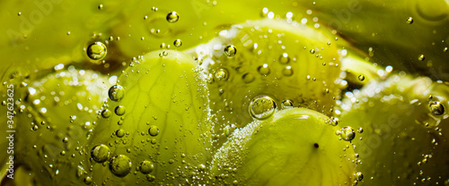 Wide fruit background with grapes and bubbles of the water close up