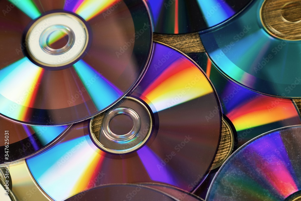 CD copmact discs in a pile shiny background CD copmact discs in a pile shiny background