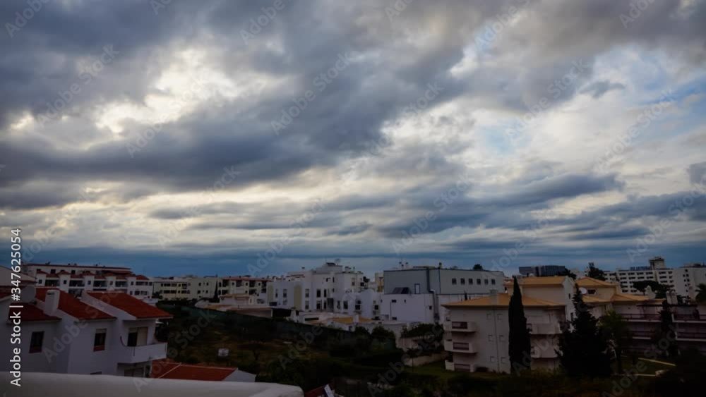 Timelapse of dramatic cloudy skies over apartment buildings in Albufeira, Algarve, Portugal. Timelapse of dramatic cloudy skies over apartment buildings in Albufeira, Algarve, Portugal.