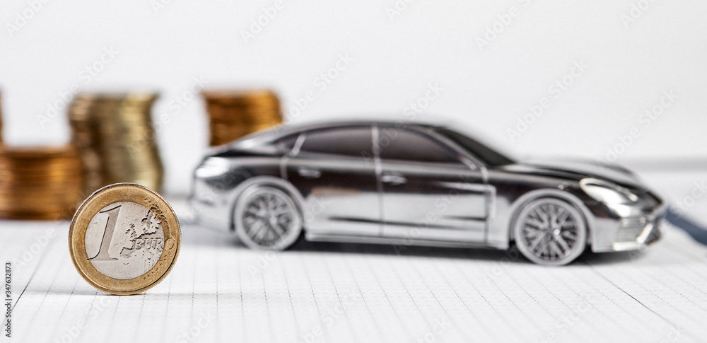 Motor or car insurance claim form with coin stack and car model.