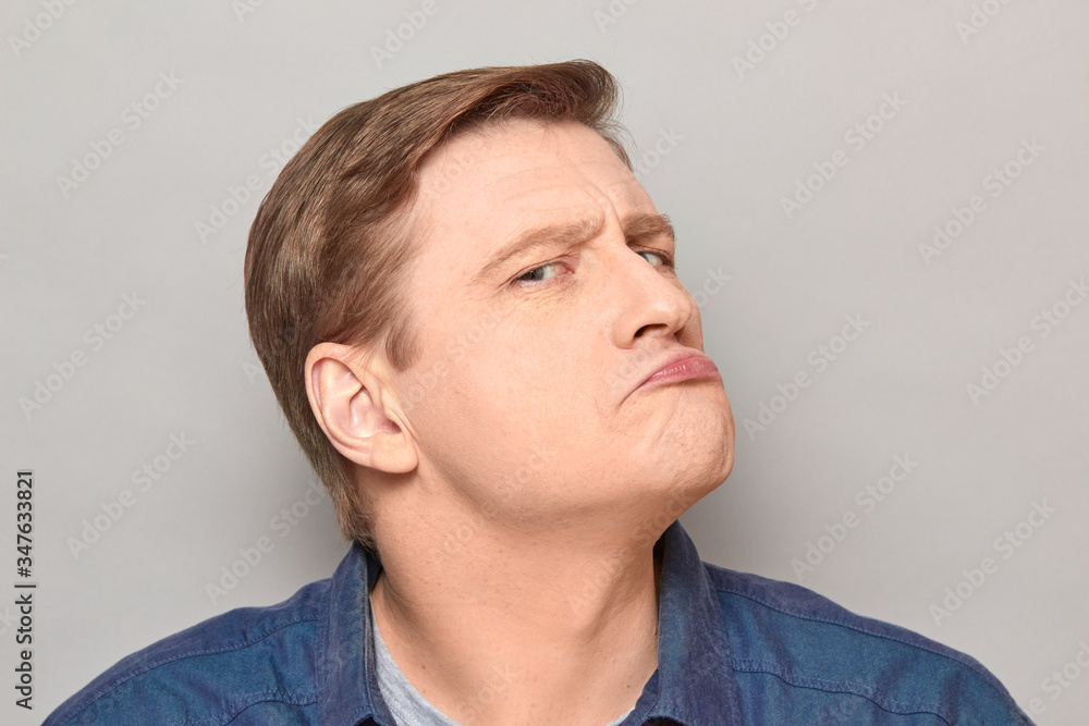 Portrait of funny thoughtful focused proud mature man