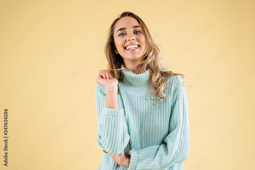 Close up thoughtful pretty girl looking with a smile. Isolated on yellow background Close up thoughtful pretty girl looking with a smile. Isolated on yellow background