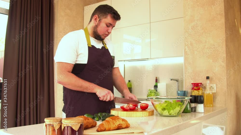 Man cutting fresh tomatoes for salad Man cutting fresh tomatoes for salad