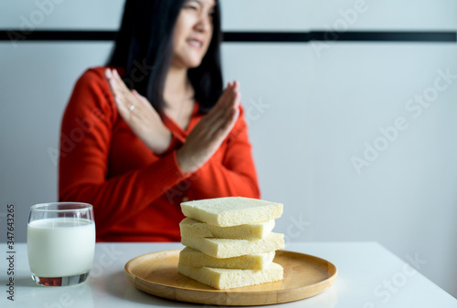 Quadro em tela Woman hands refusing white bread,Female having allergy to bread,Food intolerance