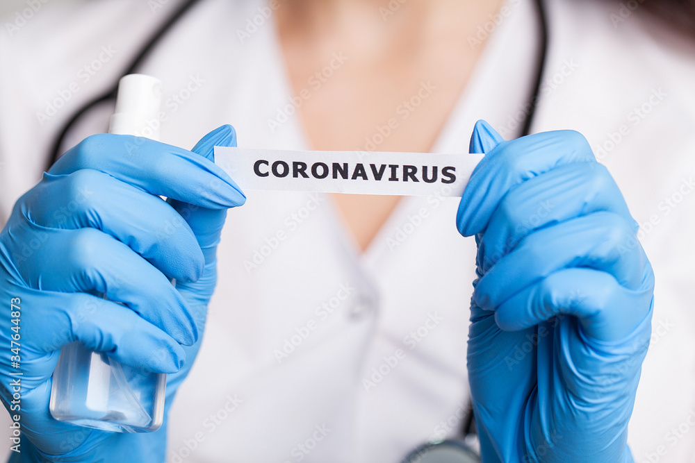 Female doctor in a white coat holding the inscription coronavirus Female doctor in a white coat holding the inscription coronavirus