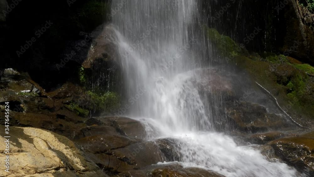 Waterfall with wind effects slow motion. Waterfall with wind effects slow motion.