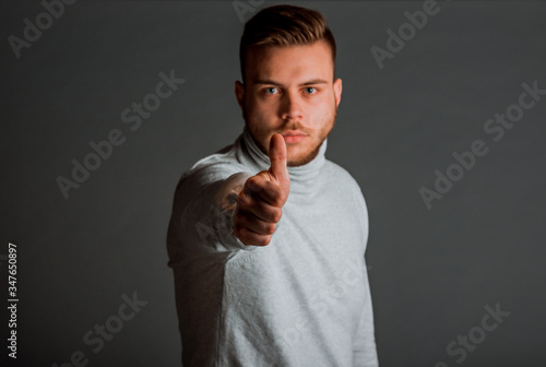 Stylish trendy man with thumbs up photo