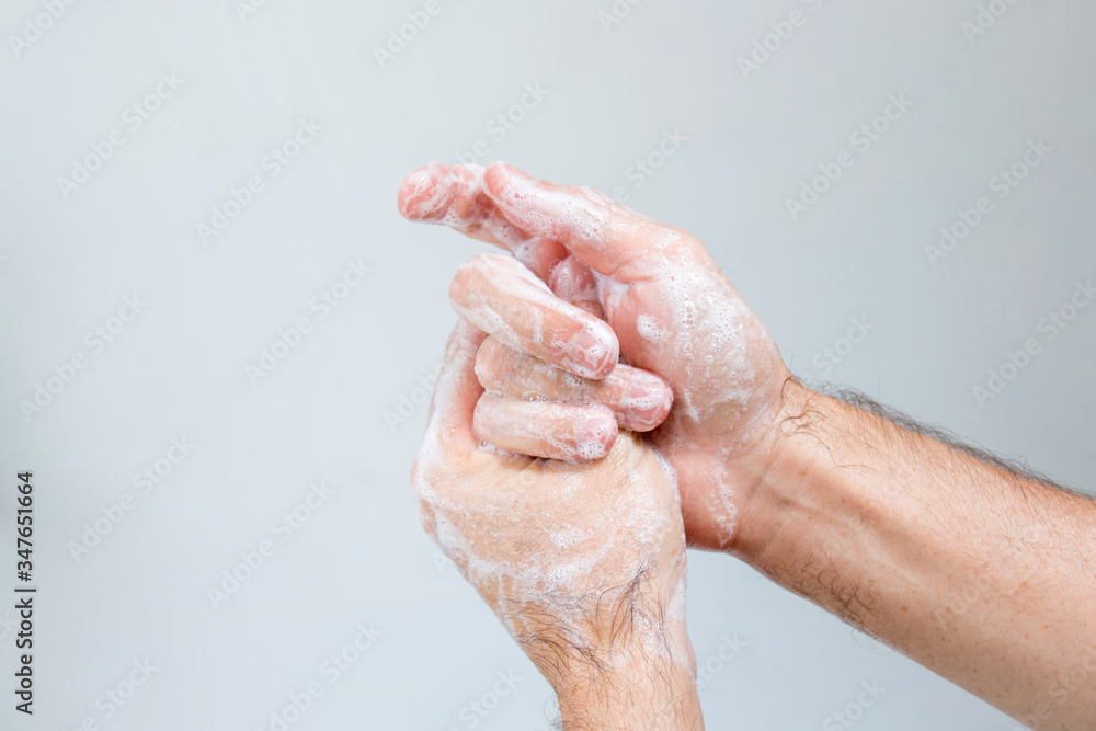 Fototapeta premium Washing hands rubbing with soap man for coronavirus, hygiene and desinfecton for prevention. Lock down, covid19. Antibacterial. Alcohol gel