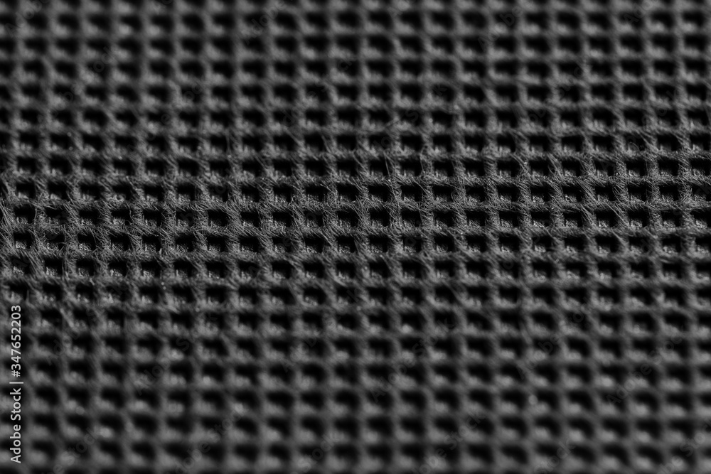 Black symmetrical synthetic fiber texture. Wattled black fabric texture. Close up. Black symmetrical synthetic fiber texture. Wattled black fabric texture. Close up.