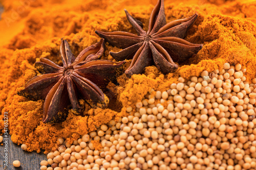 Fototapeta Different spices. Star anise, mustard seeds and turmeric powder. Macro