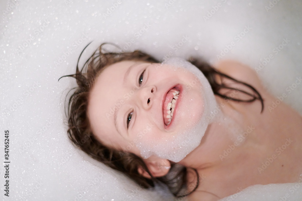 little girl in bath playing with soap foam little girl in bath playing with soap foam