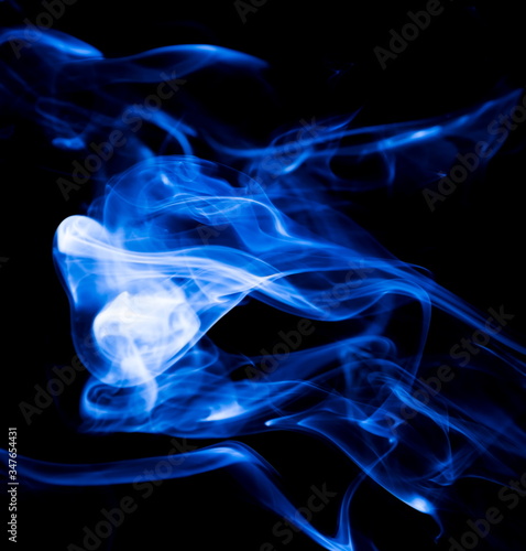 Blue smoke on black background © yauhenka