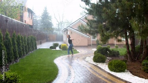 Wallpaper Mural Young woman enjoying rain in garden Torontodigital.ca