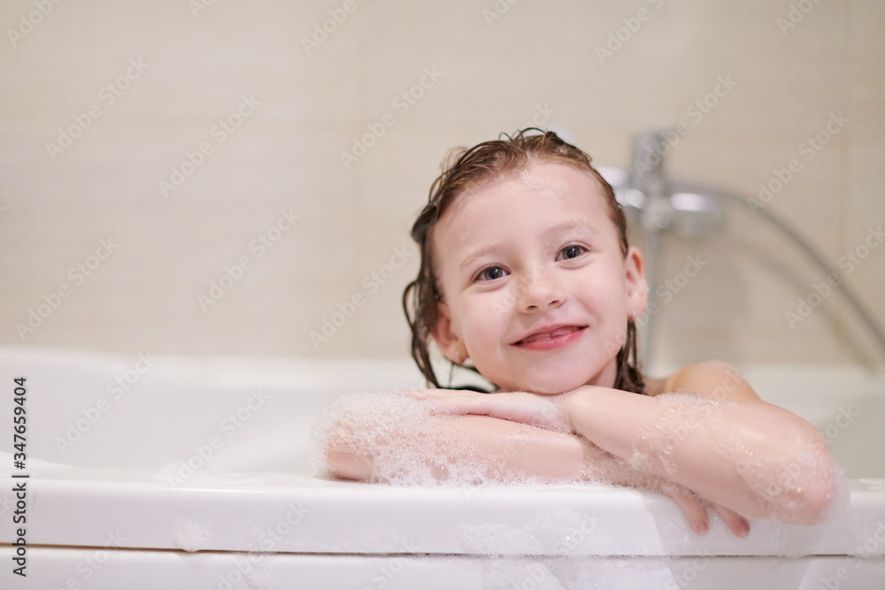 little girl in bath playing with soap foam little girl in bath playing with soap foam