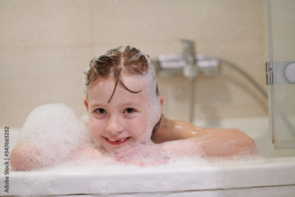 little girl in bath playing with soap foam little girl in bath playing with soap foam
