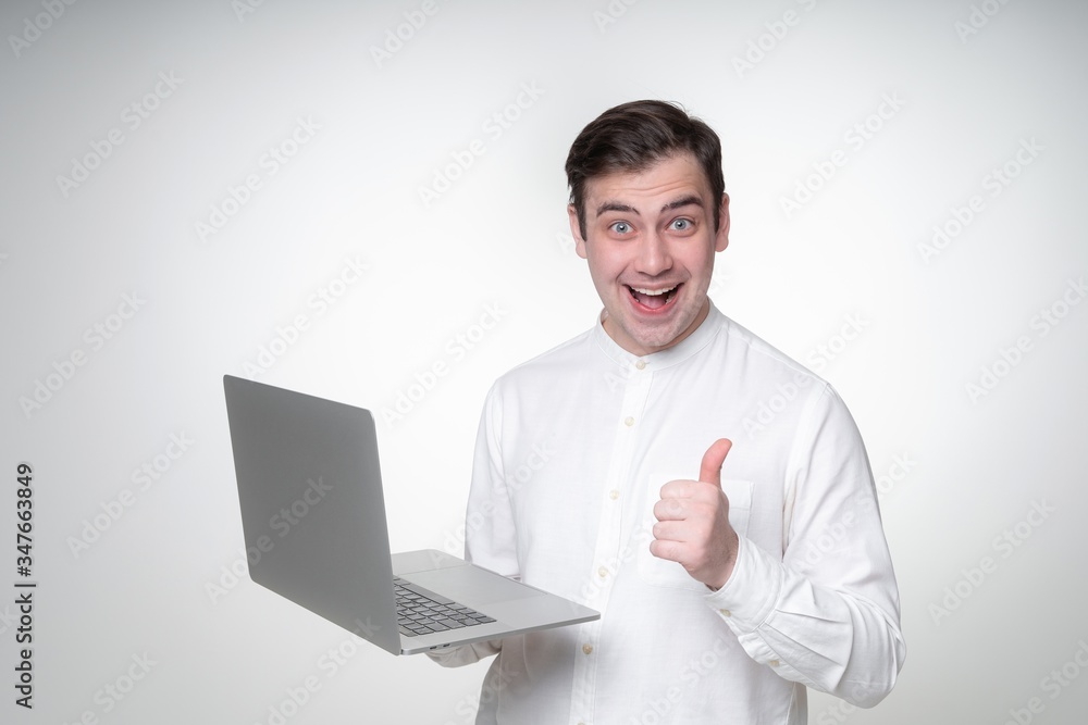 happy guy holding laptop thumbs up happy guy holding laptop thumbs up