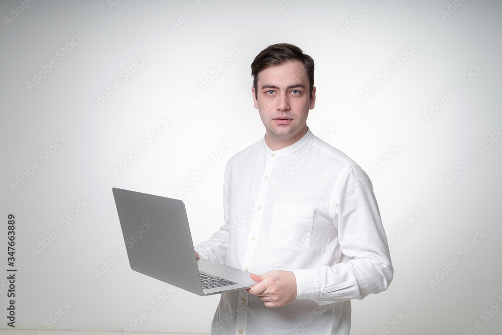 confident young man holding laptop confident young man holding laptop