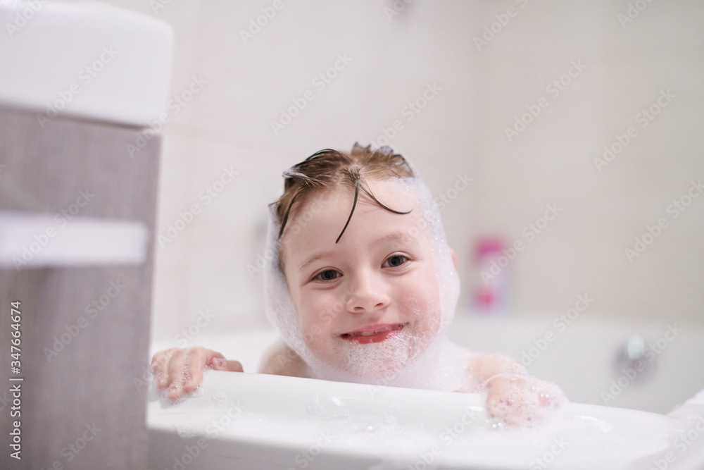 little girl in bath playing with soap foam little girl in bath playing with soap foam
