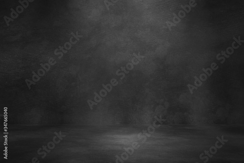 Black concrete background wall. Old surfaces that have scratches and cracks. Black room.